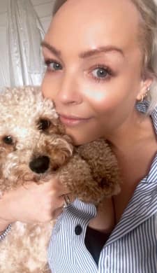 Close up image of Lexi cuddling her dog